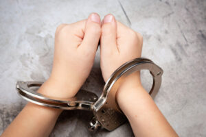 teenager in handcuffs