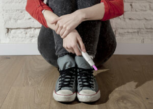 teenage girl holding pregnancy test